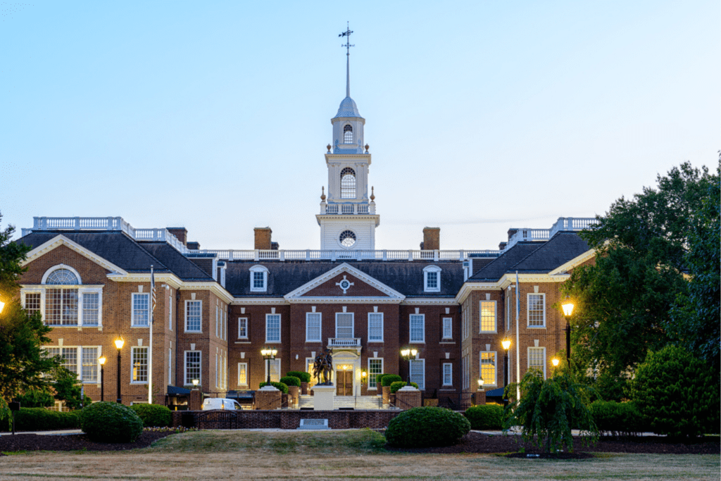 Front of Delaware Legislative Hall with lights on at dusk
