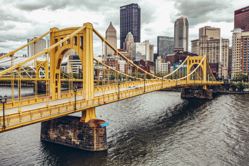 View of downtown Pittsburgh with a yellow bridge in the foreground